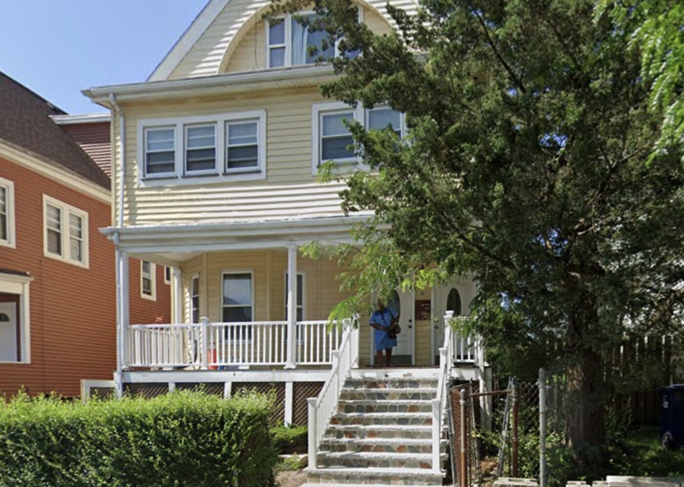 The front porch and entry of the residence on a sunny afternoon